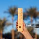 istockphoto-1200895823-1024×1024 Thermometer in hand in front of palm trees and blue sky background. Weather forecast concept
